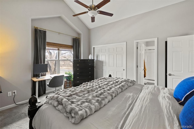 carpeted bedroom with baseboards, a ceiling fan, lofted ceiling, ensuite bath, and a closet