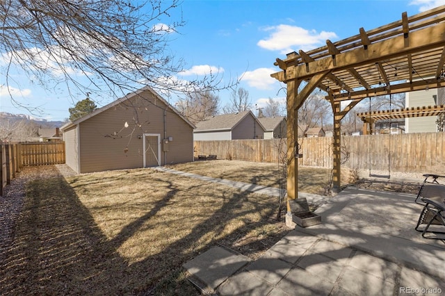 view of yard featuring an outbuilding, a patio, a fenced backyard, and a pergola