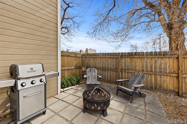 view of patio / terrace featuring an outdoor fire pit, a fenced backyard, and area for grilling