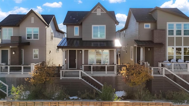 rear view of property featuring covered porch