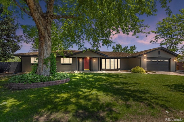 2180 Myrtlewood Ln, Lakewood, CO 80215 - ranch-style house with an attached garage, a lawn, and driveway