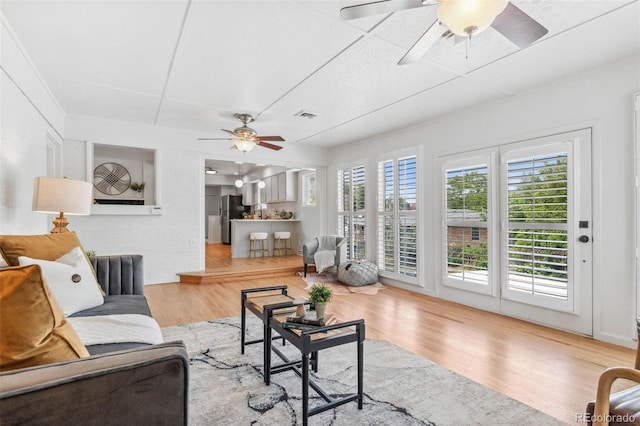 2180 Myrtlewood Ln, Lakewood, CO 80215 - living area with a ceiling fan, plenty of natural light, and wood finished floors