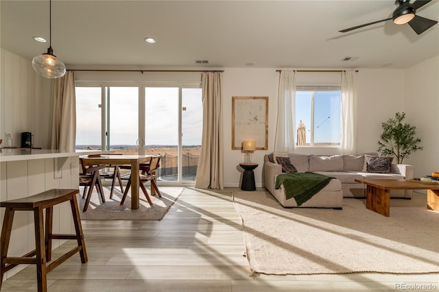 interior space with ceiling fan and light hardwood / wood-style flooring