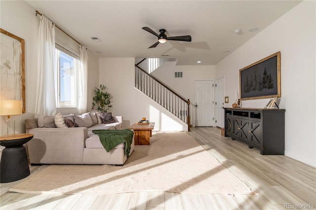 living room featuring light wood-type flooring and ceiling fan