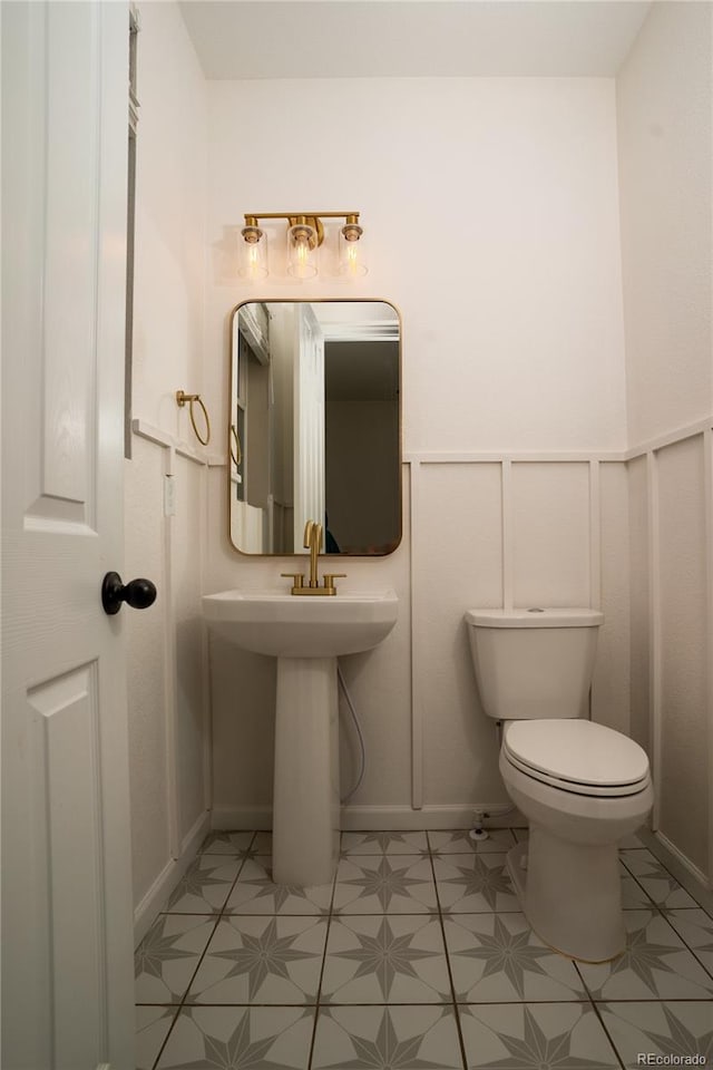 bathroom featuring toilet and tile patterned flooring