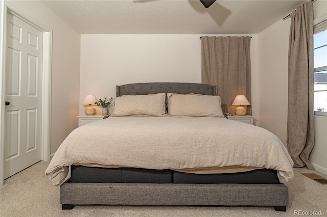 bedroom with light carpet and ceiling fan