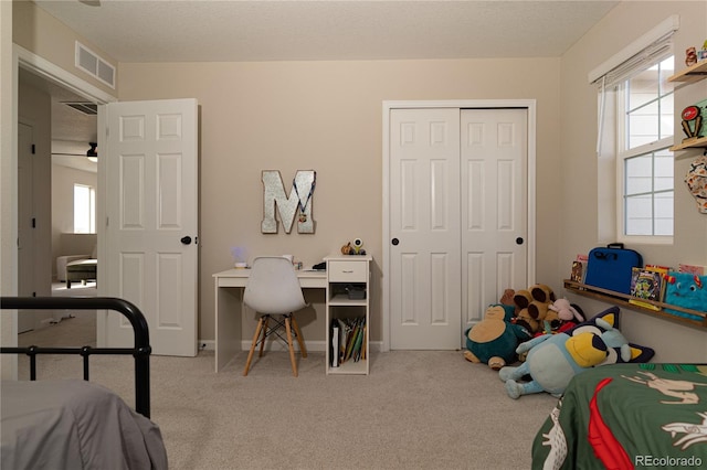 carpeted bedroom featuring a closet