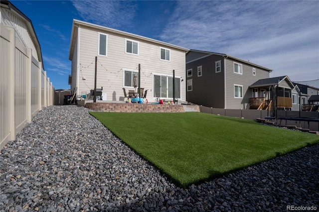 rear view of house with a yard and a patio