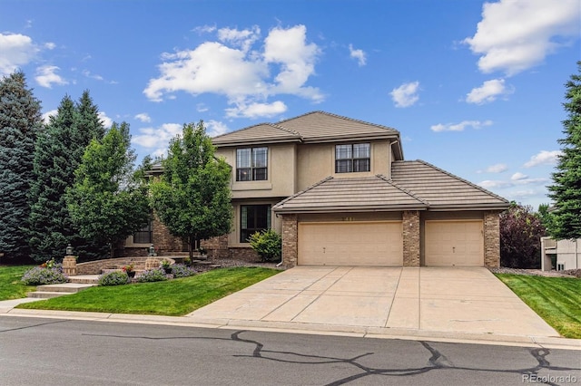 9411 E Hidden Hill Ln, Lone Tree, CO 80124 - traditional-style house featuring brick siding, a garage, concrete driveway, and a front yard