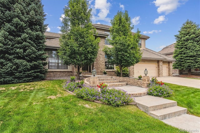 9411 E Hidden Hill Ln, Lone Tree, CO 80124 - obstructed view of property featuring driveway, a front lawn, and brick siding