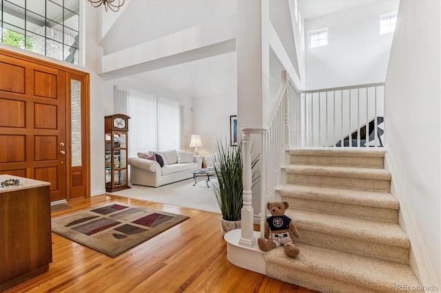 9411 E Hidden Hill Ln, Lone Tree, CO 80124 - foyer entrance with a high ceiling, wood finished floors, stairs, and healthy amount of natural light