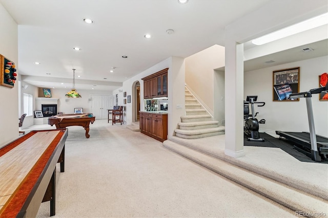 9411 E Hidden Hill Ln, Lone Tree, CO 80124 - rec room with billiards table, light colored carpet, recessed lighting, arched walkways, and a glass covered fireplace
