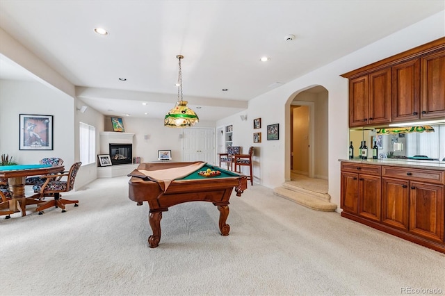 9411 E Hidden Hill Ln, Lone Tree, CO 80124 - playroom featuring billiards, light carpet, arched walkways, recessed lighting, and a glass covered fireplace
