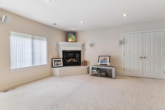 9411 E Hidden Hill Ln, Lone Tree, CO 80124 - living room with a glass covered fireplace, carpet flooring, and recessed lighting