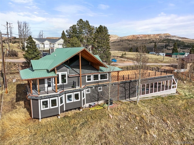 137 Hayden St, Cripple Creek, CO 80813 - back of property featuring fence, a mountain view, a balcony, and metal roof