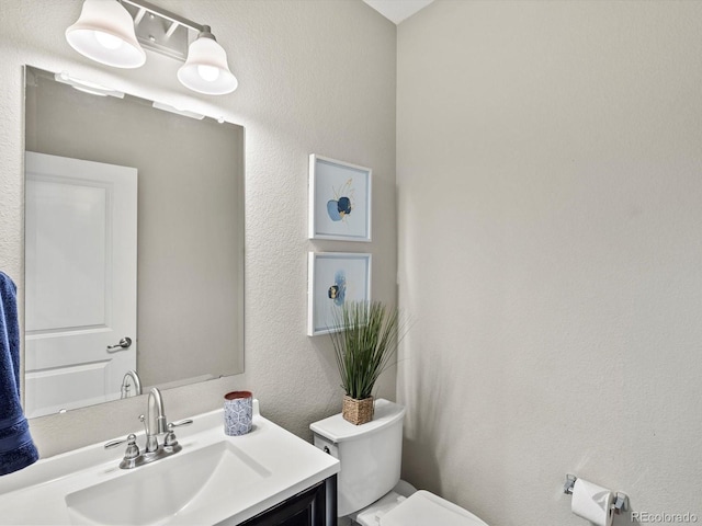 8012 E 50th Dr, Denver, CO 80238 - half bathroom featuring vanity and a textured wall