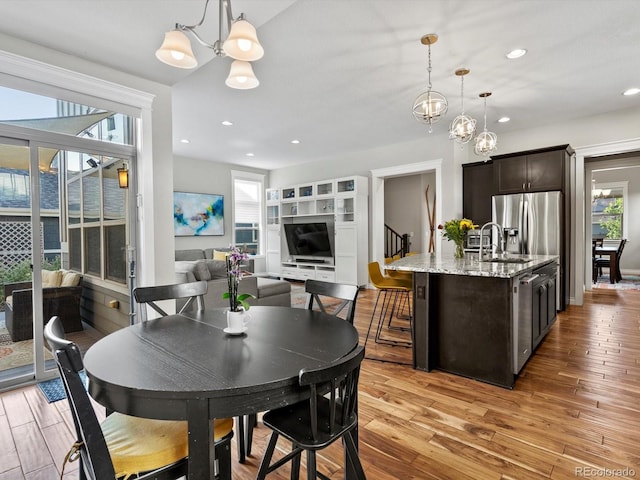 8012 E 50th Dr, Denver, CO 80238 - dining space with a chandelier, light wood-type flooring, and recessed lighting