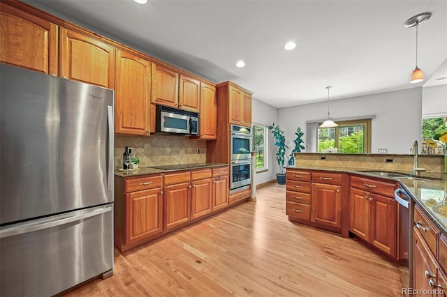 6475 Umber Cir, Arvada, CO 80007 - kitchen with appliances with stainless steel finishes, recessed lighting, decorative backsplash, and brown cabinets