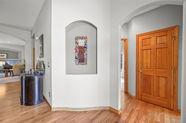6475 Umber Cir, Arvada, CO 80007 - hall with arched walkways and light wood-type flooring