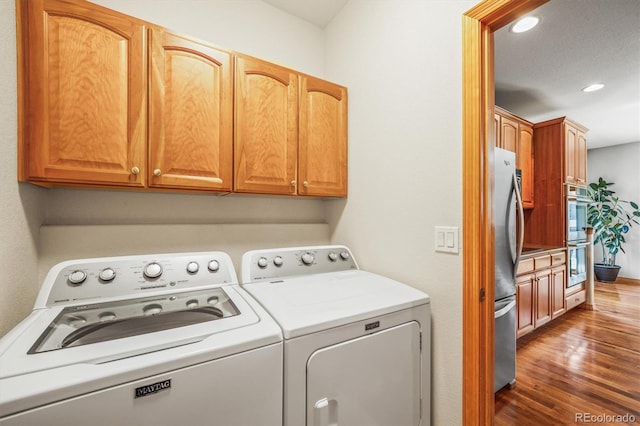 6475 Umber Cir, Arvada, CO 80007 - washroom featuring washer and dryer, dark wood-style flooring, cabinet space, and recessed lighting