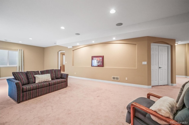 6475 Umber Cir, Arvada, CO 80007 - living room with arched walkways, recessed lighting, and light carpet