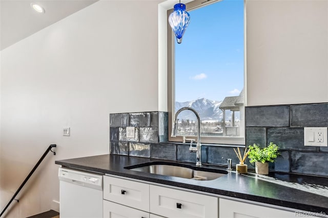 kitchen featuring white cabinets, a mountain view, sink, and white dishwasher