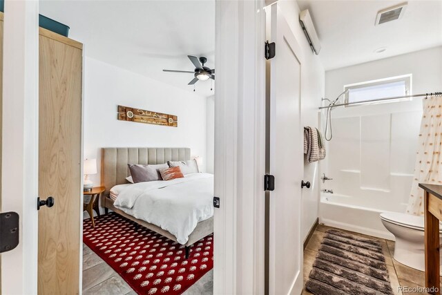 tiled bedroom with ceiling fan and a wall mounted AC