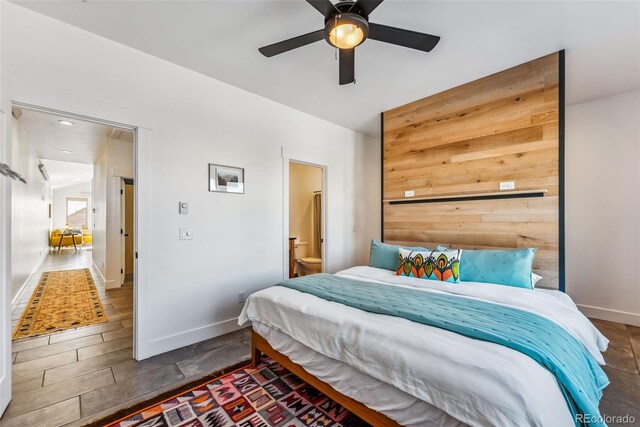 bedroom with ensuite bath and ceiling fan