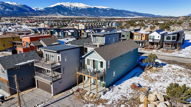 snowy aerial view with a mountain view