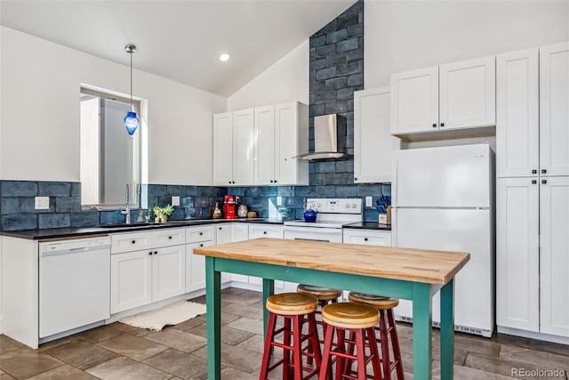 kitchen with white cabinets, wall chimney exhaust hood, white appliances, and lofted ceiling