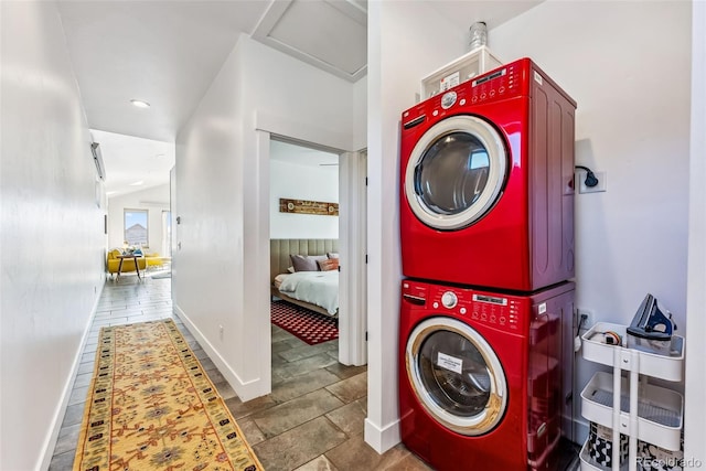 washroom featuring stacked washing maching and dryer