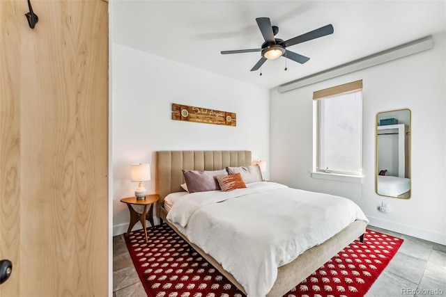 tiled bedroom featuring ceiling fan