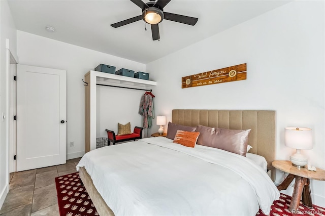 bedroom with ceiling fan and light tile patterned flooring