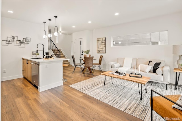 1344 N Knox Ct, Denver, CO 80204 - living area featuring stairs, light wood finished floors, and recessed lighting