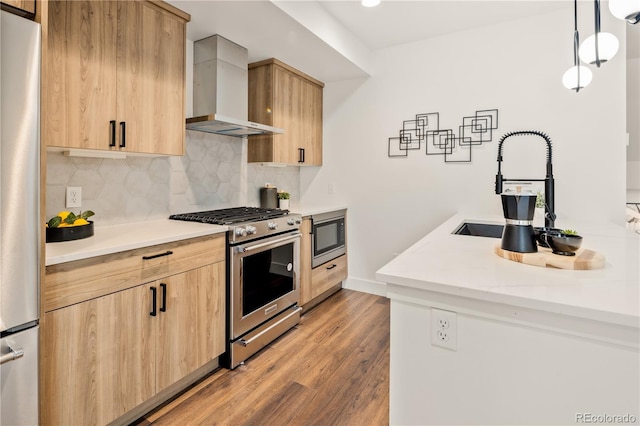 1344 N Knox Ct, Denver, CO 80204 - kitchen with stainless steel appliances, wall chimney range hood, light brown cabinets, and light wood-type flooring