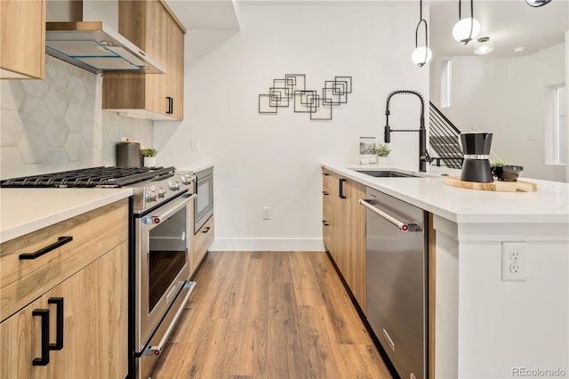1344 N Knox Ct, Denver, CO 80204 - kitchen featuring appliances with stainless steel finishes, wall chimney exhaust hood, modern cabinets, and light brown cabinetry