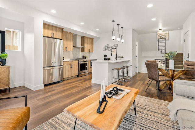 1344 N Knox Ct, Denver, CO 80204 - living area featuring wood finished floors, stairs, and recessed lighting