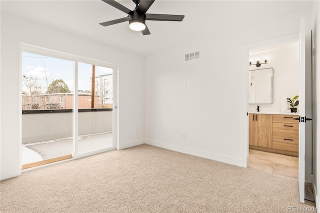 1344 N Knox Ct, Denver, CO 80204 - unfurnished bedroom with light carpet, ensuite bath, and a ceiling fan
