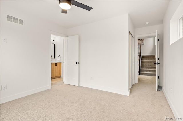 1344 N Knox Ct, Denver, CO 80204 - unfurnished bedroom with light carpet, a closet, ensuite bath, a spacious closet, and a ceiling fan