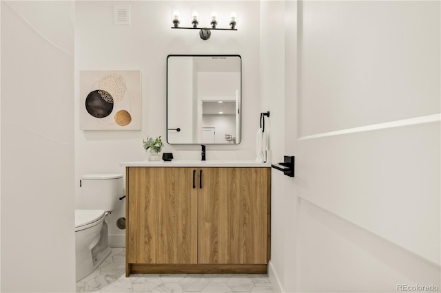 1344 N Knox Ct, Denver, CO 80204 - half bathroom featuring vanity and marble finish flooring