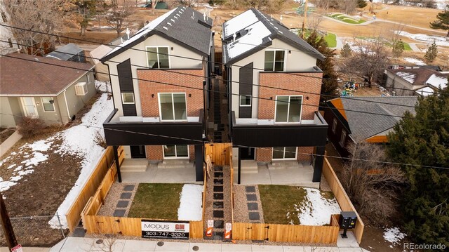 1344 N Knox Ct, Denver, CO 80204 - view of front of property with brick siding, a fenced front yard, a patio, and a gate