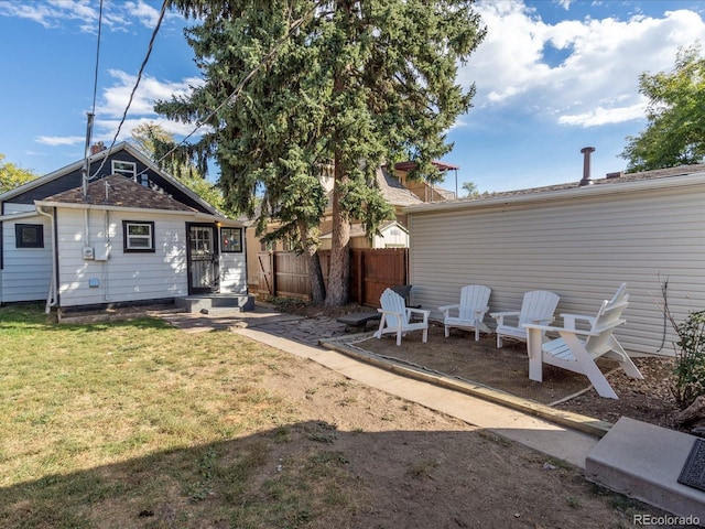 rear view of house featuring a lawn