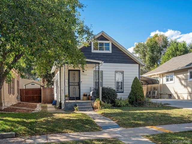 bungalow-style house with a carport and a front yard