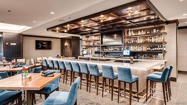 bar featuring recessed lighting, a community bar, and coffered ceiling