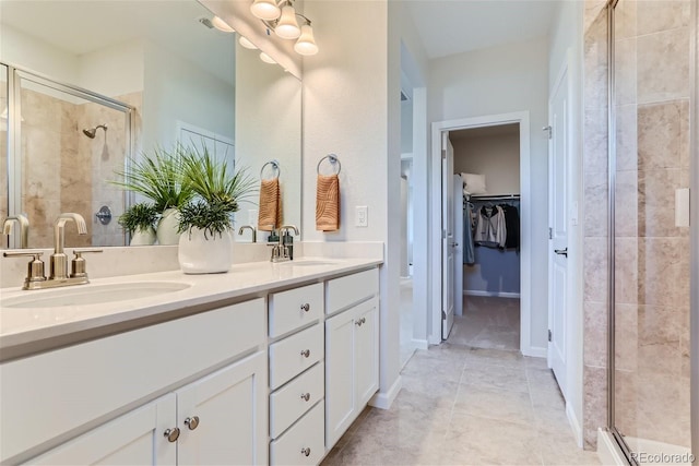 bathroom with vanity, tile patterned flooring, and walk in shower