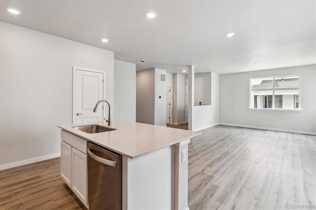 14101 Deertrack Ln, Parker, CO 80134 - kitchen with a sink, stainless steel dishwasher, light wood finished floors, a kitchen island with sink, and baseboards