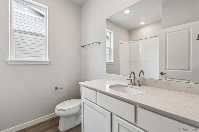 14101 Deertrack Ln, Parker, CO 80134 - full bathroom with baseboards, toilet, vanity, wood finished floors, and a shower