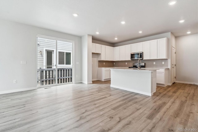14101 Deertrack Ln, Parker, CO 80134 - kitchen with appliances with stainless steel finishes, tasteful backsplash, baseboards, light countertops, and recessed lighting