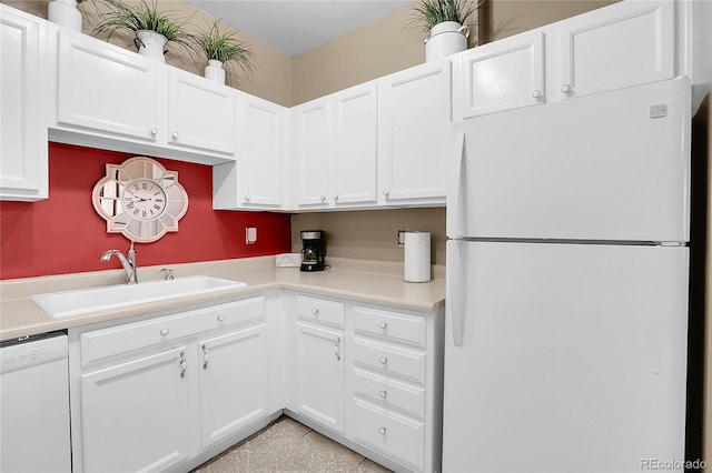 kitchen featuring white cabinets, sink, and white appliances