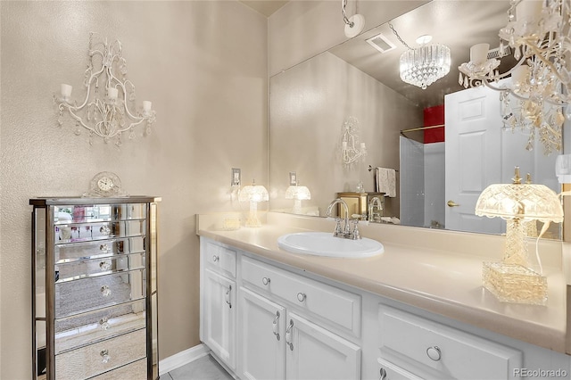 bathroom with vanity and a chandelier